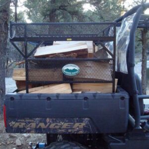 black metal rack on the back of an UTV filled with wooden boxes